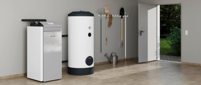 A clean, modern utility room features a water heater and boiler against a beige wall. Gardening tools and a watering can are neatly organized on hooks. A door opens to a green garden outside, allowing natural light into the space.